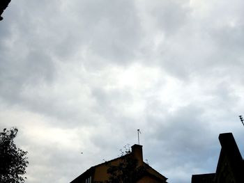 Low angle view of building against cloudy sky