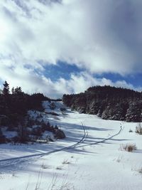 Scenic view of snowcapped landscape against sky