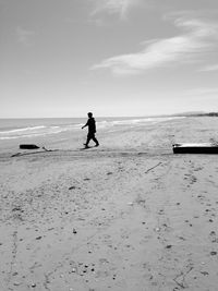 Man on beach against sky