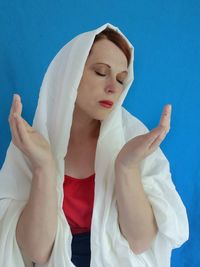 Midsection of woman standing against white background