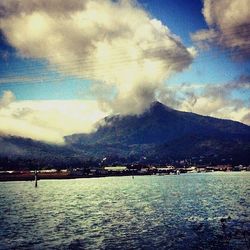 Scenic view of sea against cloudy sky