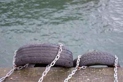 Close-up of tires on pier