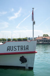 Information sign on river against sky