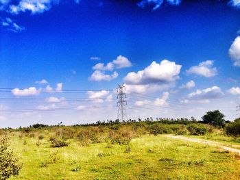 Scenic view of grassy field against cloudy sky