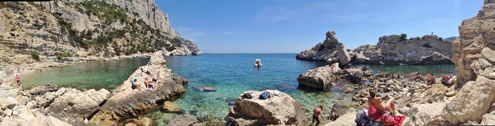 Panoramic view of rocks on beach against sky