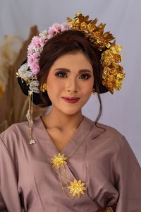 Portrait of beautiful woman with red flower