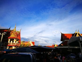 People in city against blue sky