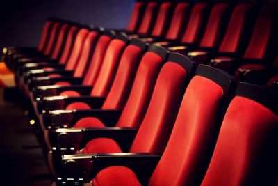 Empty red seats in row at movie theater