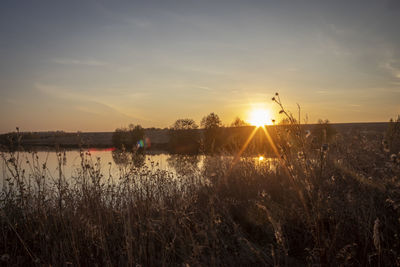 Scenic view of lake against sky during sunset