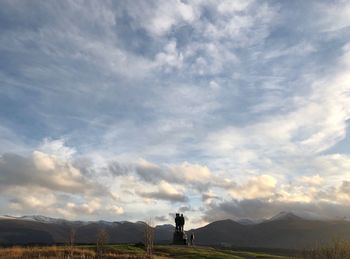 Man standing on landscape against sky