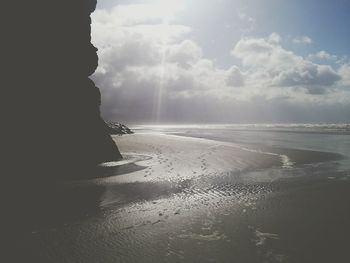 Scenic view of sea against cloudy sky