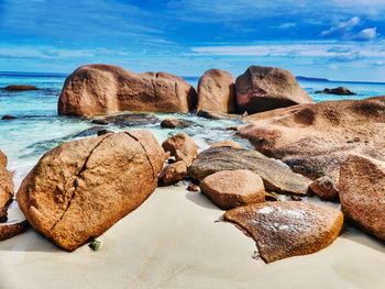 Rocks on beach against sky