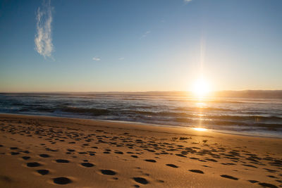 Scenic view of beach against sky during sunset