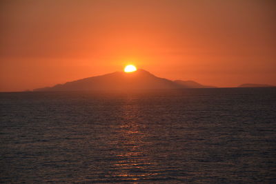 Scenic view of sea against orange sky