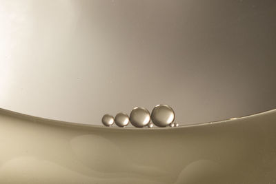 Close-up of water in plate against white background