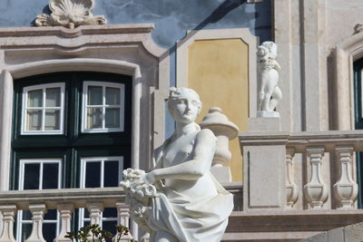Statue against historic building