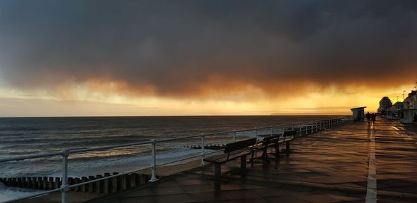 Scenic view of sea against sky during sunset after rain