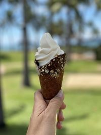 Close-up of hand holding ice cream cone