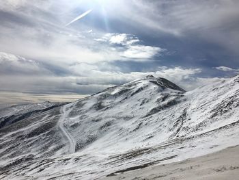 Scenic view of snow mountains against sky