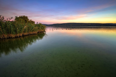 Scenic view of lake against sky during sunset