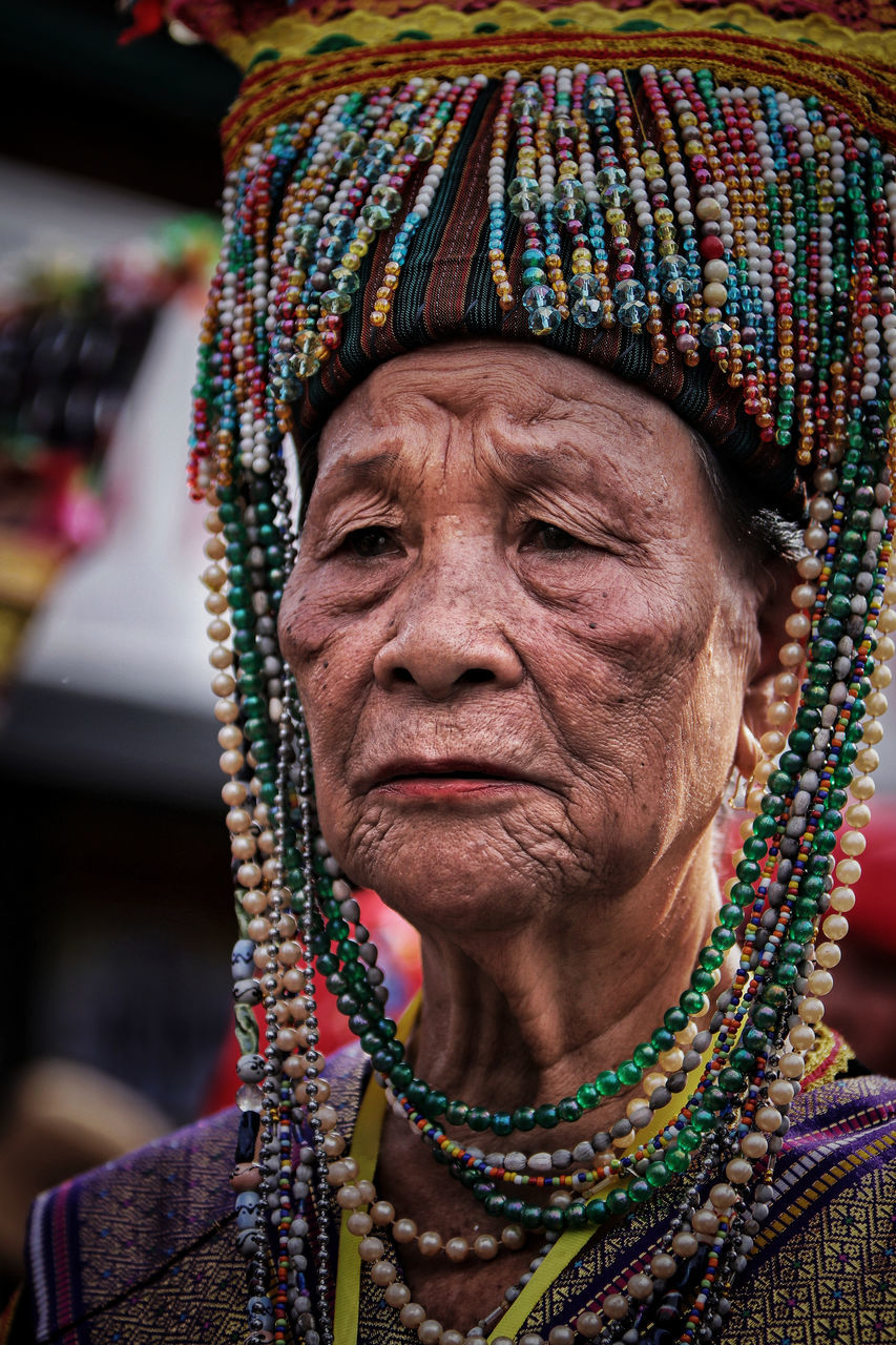 one person, portrait, headshot, adult, senior women, senior adult, clothing, real people, women, close-up, front view, lifestyles, jewelry, focus on foreground, traditional clothing, wrinkled, day, human body part, body part, human face, contemplation