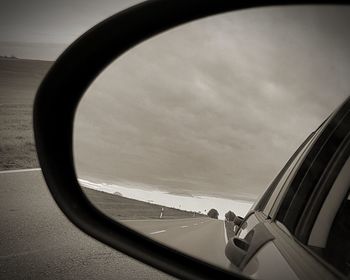 Reflection of sky on side-view mirror