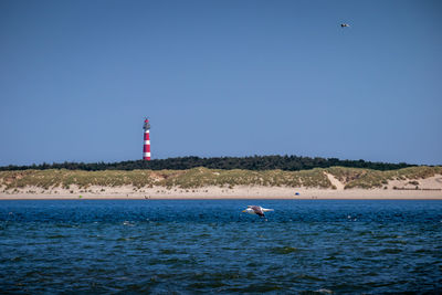 Scenic view of sea against clear blue sky