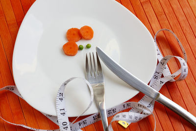 High angle view of orange fruit in plate on table