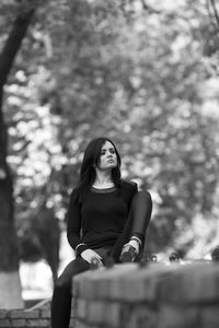 Portrait of young woman sitting on seat
