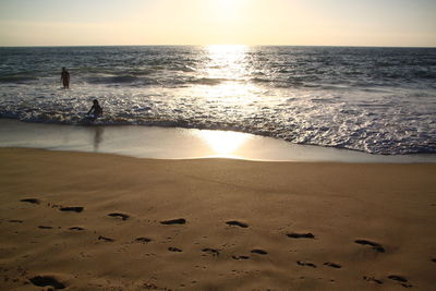 Scenic view of beach at sunset