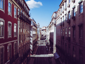 Street amidst buildings in city against sky