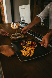 Midsection of man preparing food on table