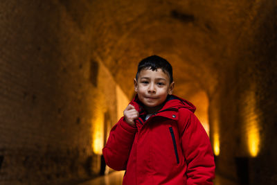 Young man standing against wall