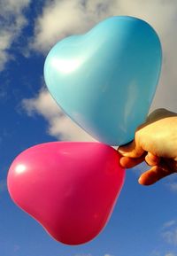 Low angle view of balloons against blue sky