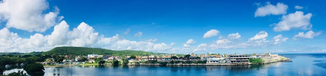 Panoramic view of sea and buildings against sky