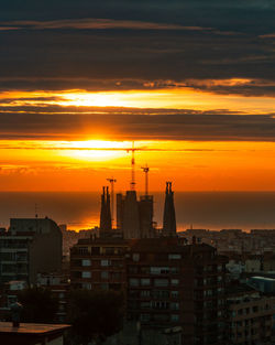 Buildings against sky during sunset