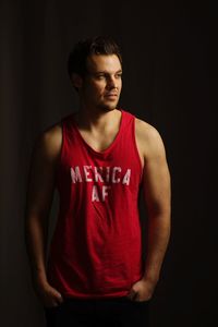 Portrait of mid adult man over black background