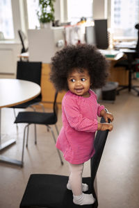 Cute girl standing on chair