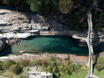 High angle view of river amidst mountains during sunny day