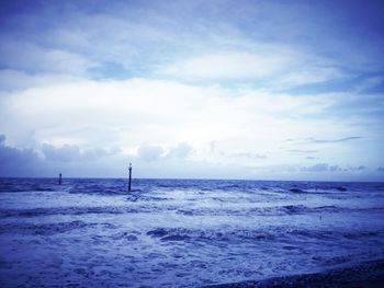 Scenic view of sea against cloudy sky