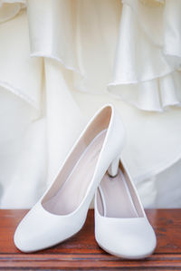 Close-up of white shoes on table
