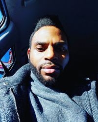 Portrait of young man in car