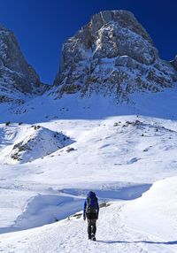 Full length of person on snowcapped mountain against sky