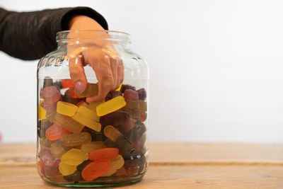 Close-up of multi colored glass jar on table