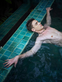 High angle view of young woman swimming in pool