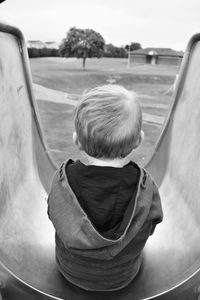 Rear view of boy sitting in car