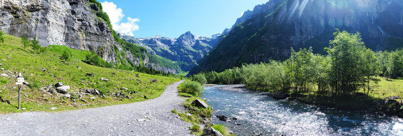 Road amidst plants and mountains against sky