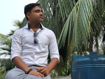 Young man sitting outdoors