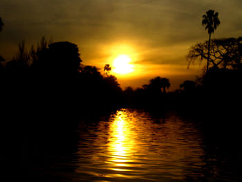 Scenic view of lake against sky during sunset