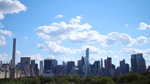 Cityscape against cloudy sky